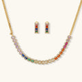 Jewelry set with rainbow beads on a gold chain necklace and earrings on a white background