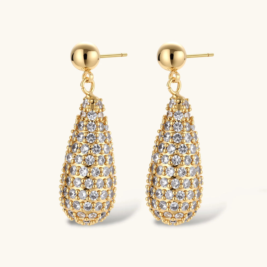 Gold teardrop earrings with clear gemstones on a white background