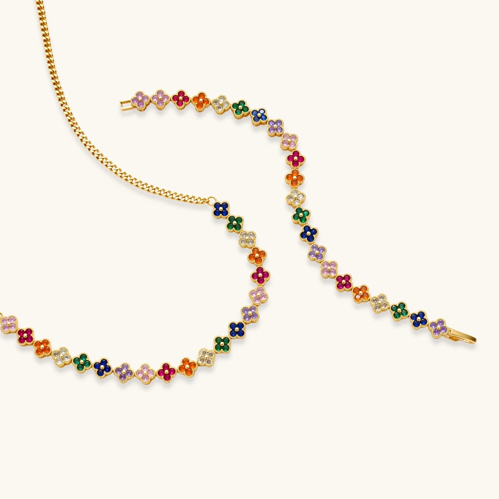 Multicolored floral necklace on a gold chain against a white background