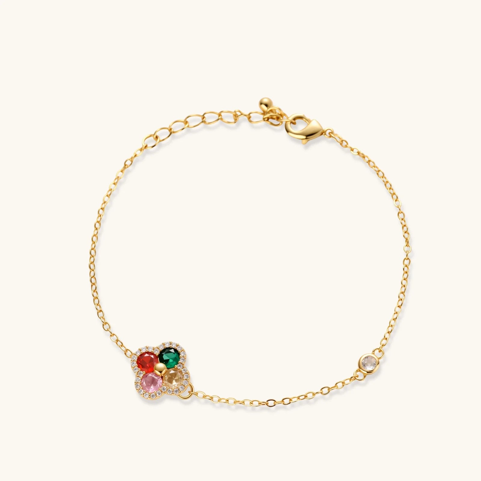 Gold bracelet with colorful gemstones on a white background