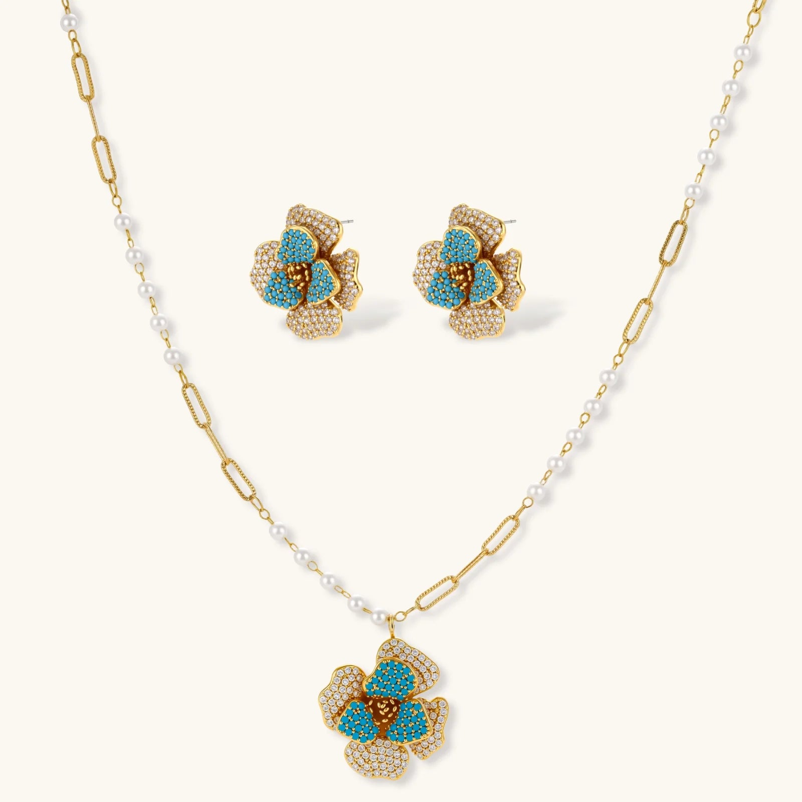 Jewelry set with floral earrings and necklace on a white background