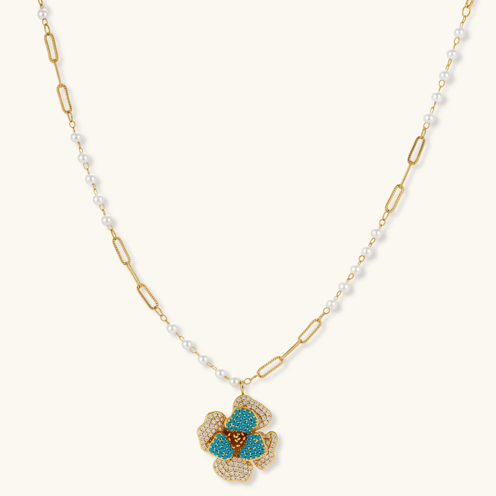Necklace with a sparkly floral pendant on a gold chain with inset pearls 