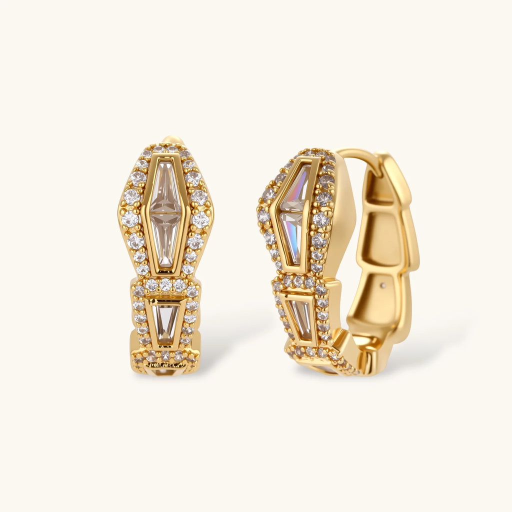 Gold hoop earrings with gemstones on a white background
