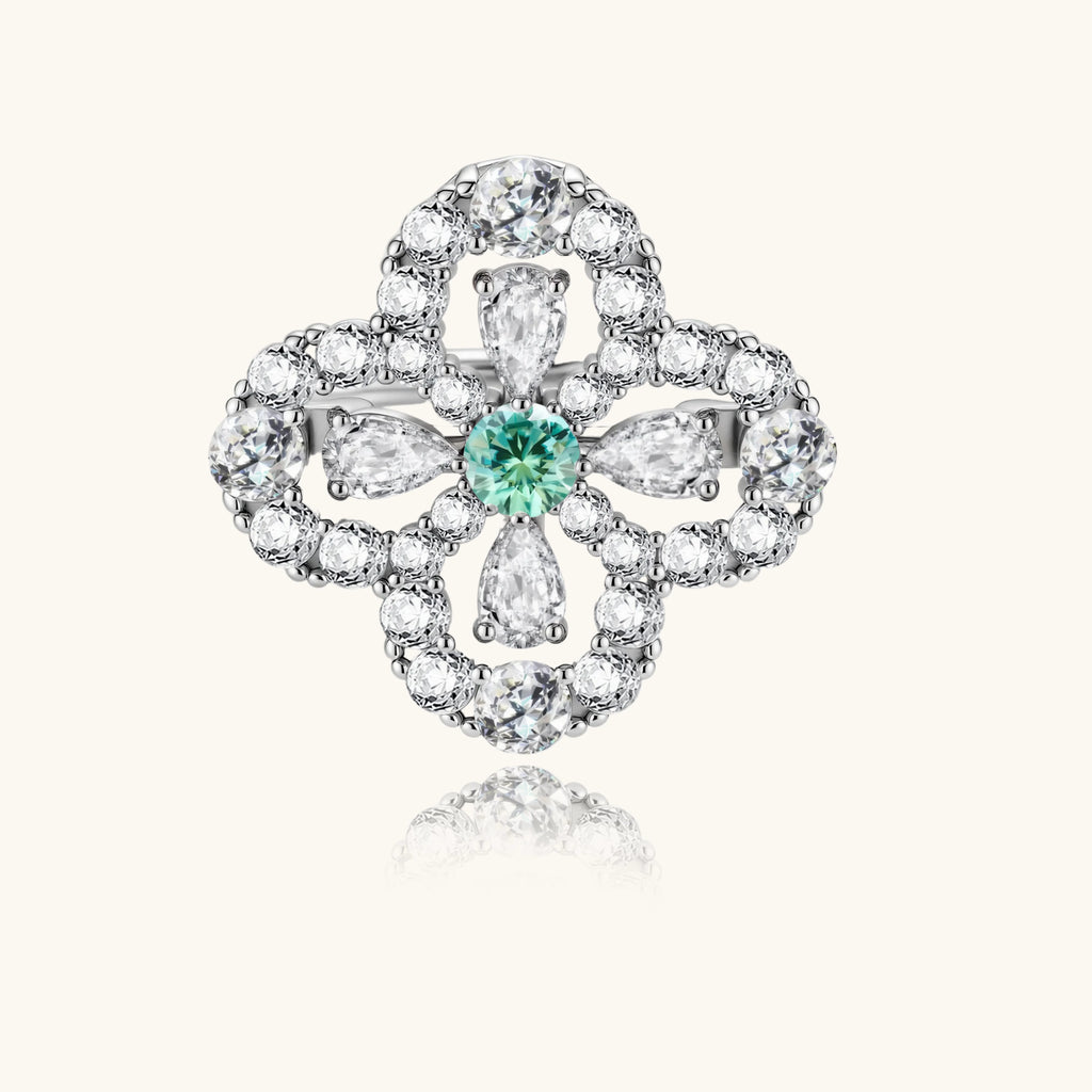 Diamante ring with a central green gemstone on a white background