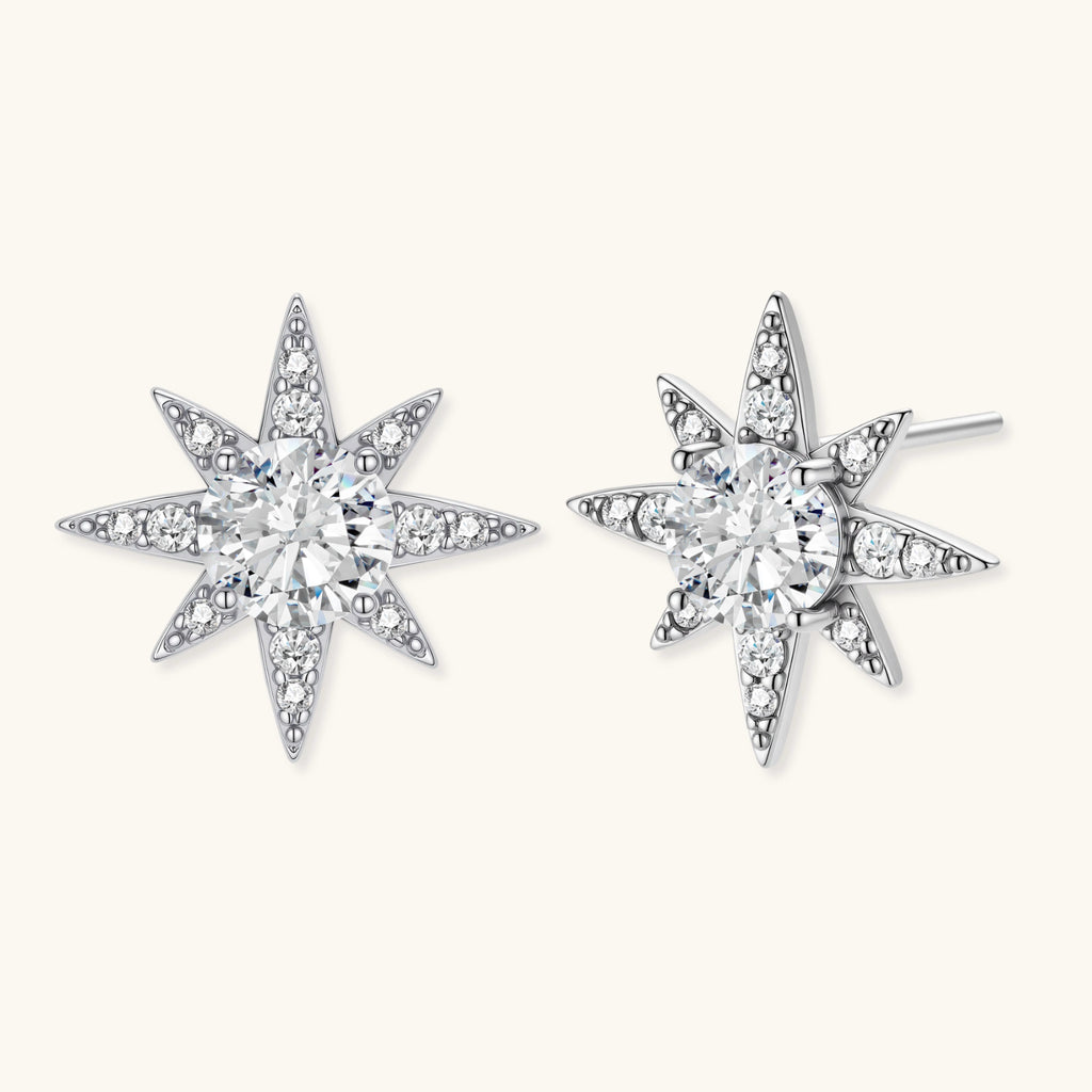 Star-shaped earrings with clear gemstones on a white background