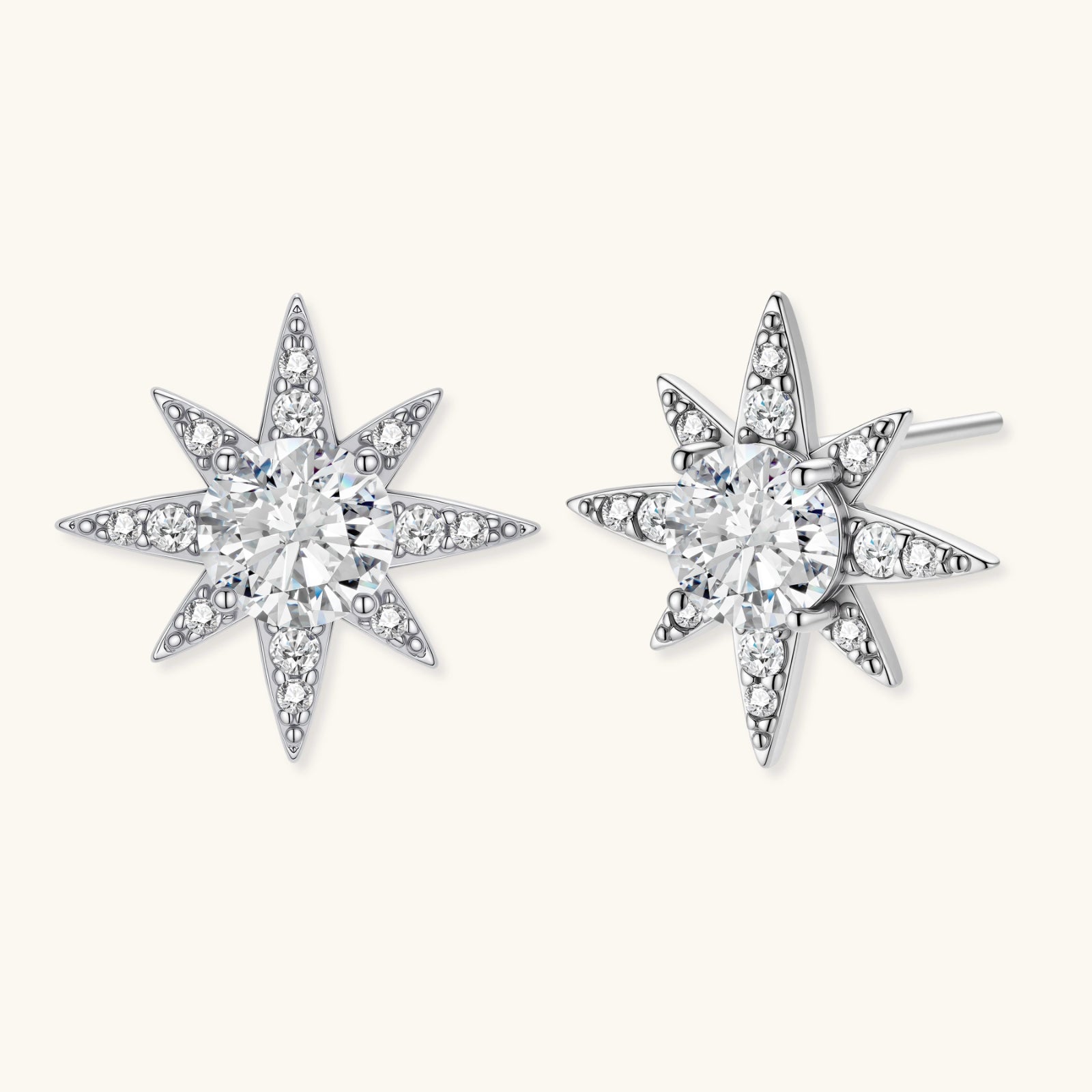 Star-shaped earrings with clear gemstones on a white background