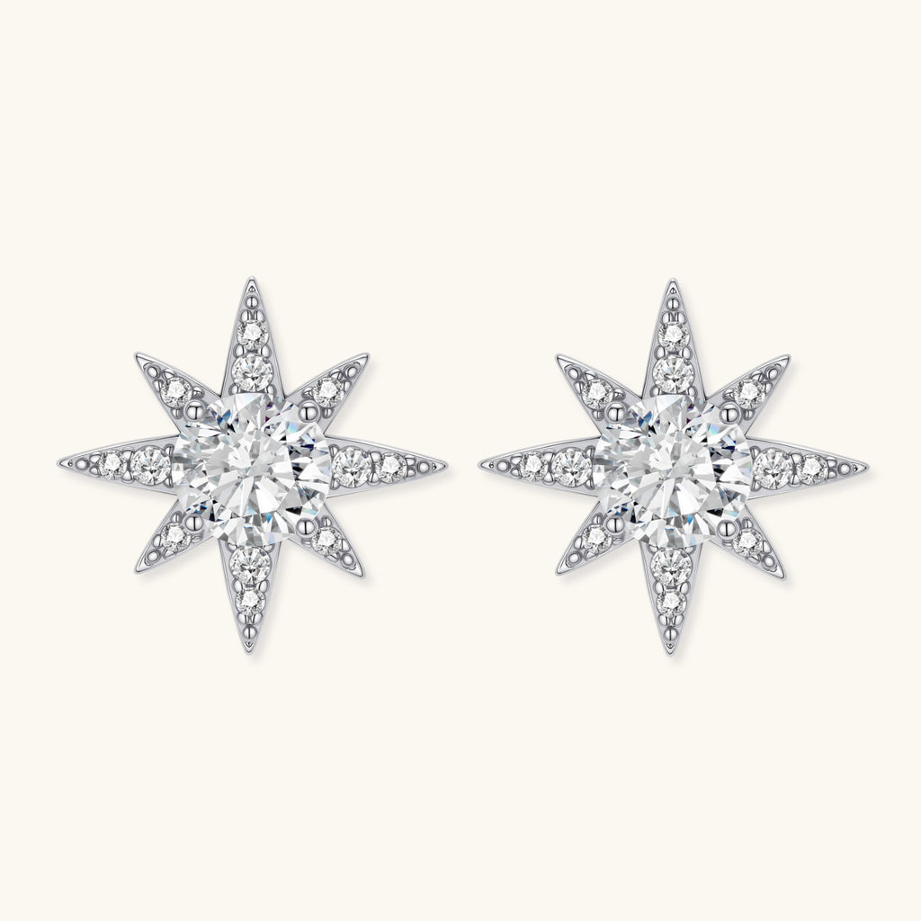 Star-shaped diamond earrings on a white background