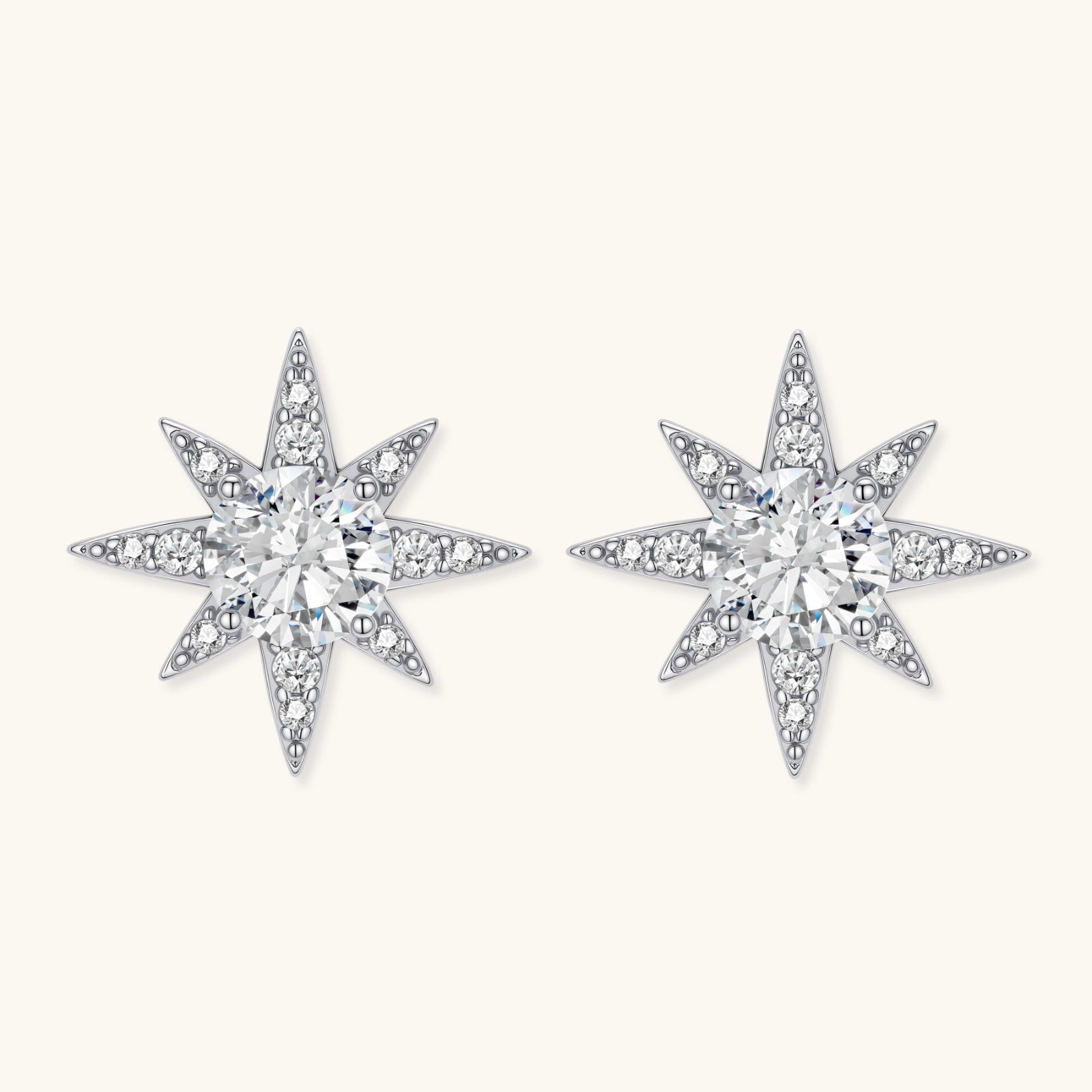 Star-shaped diamond earrings on a white background