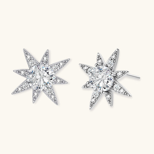 Star-shaped earrings with clear diamonds on a white background