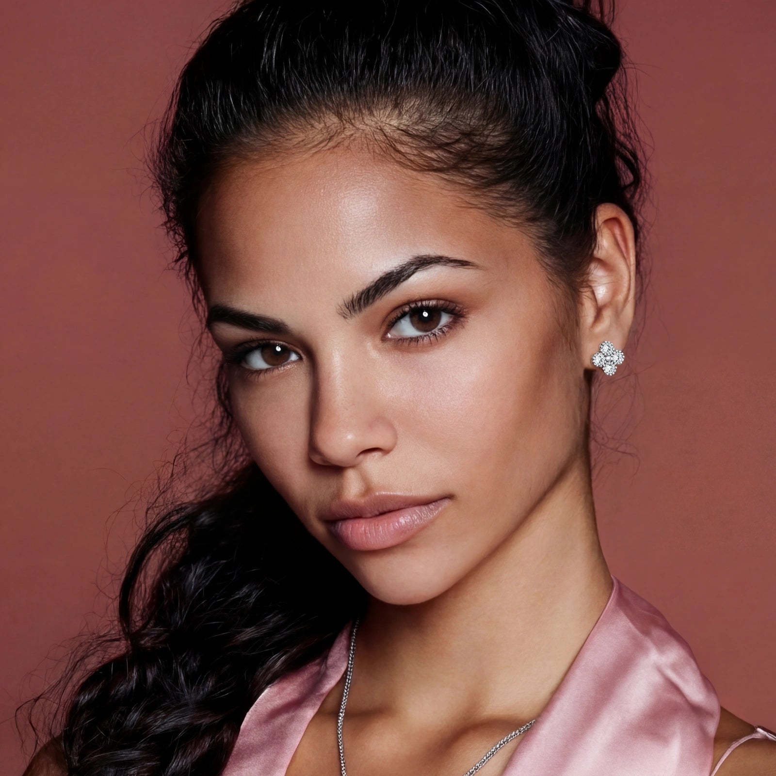 Woman wearing a pink satin garment against a red background