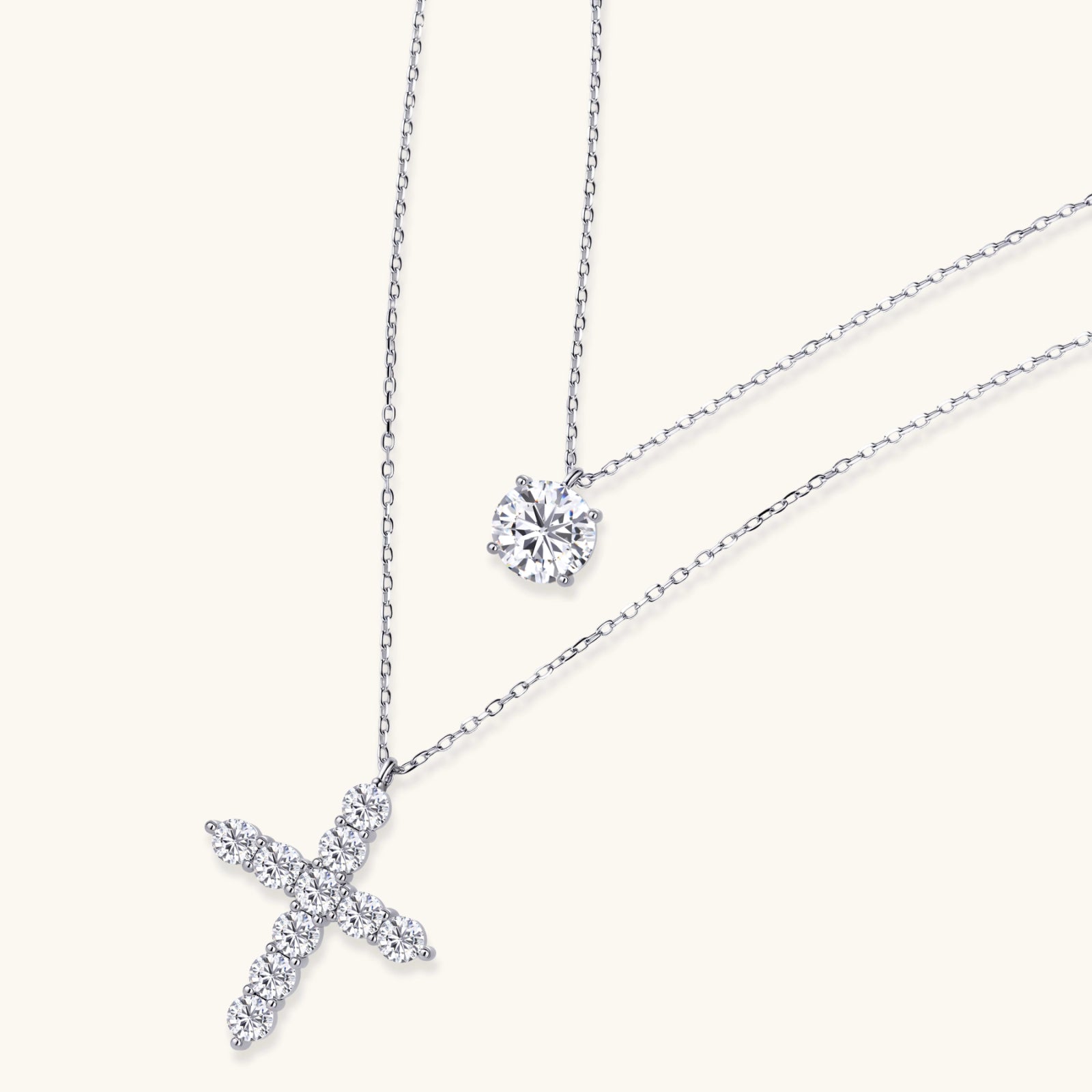 Diamond cross necklace and round diamond earring on a white background