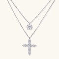 Two diamond pendants on silver chains against a white background