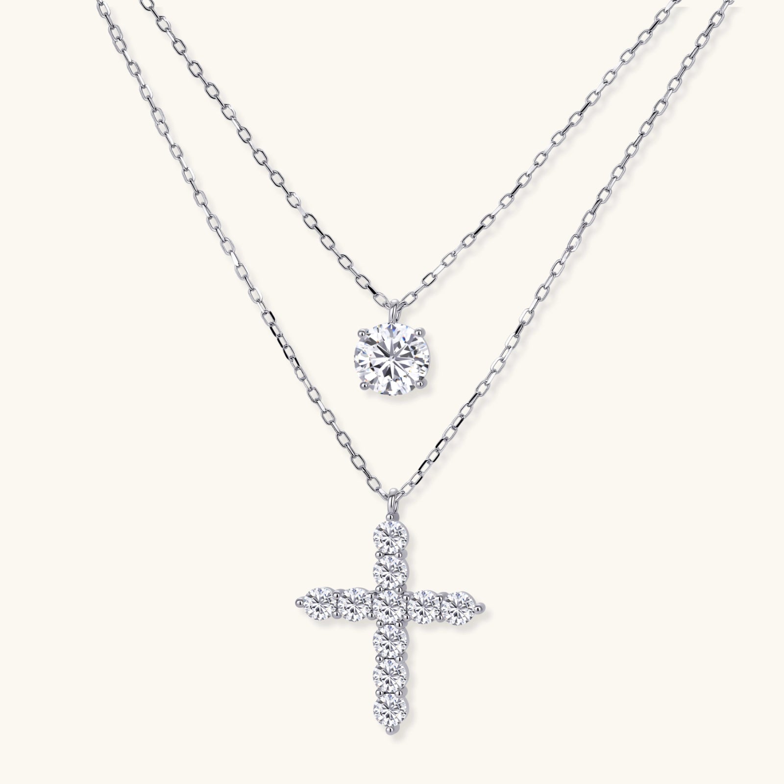 Two diamond pendants on silver chains against a white background