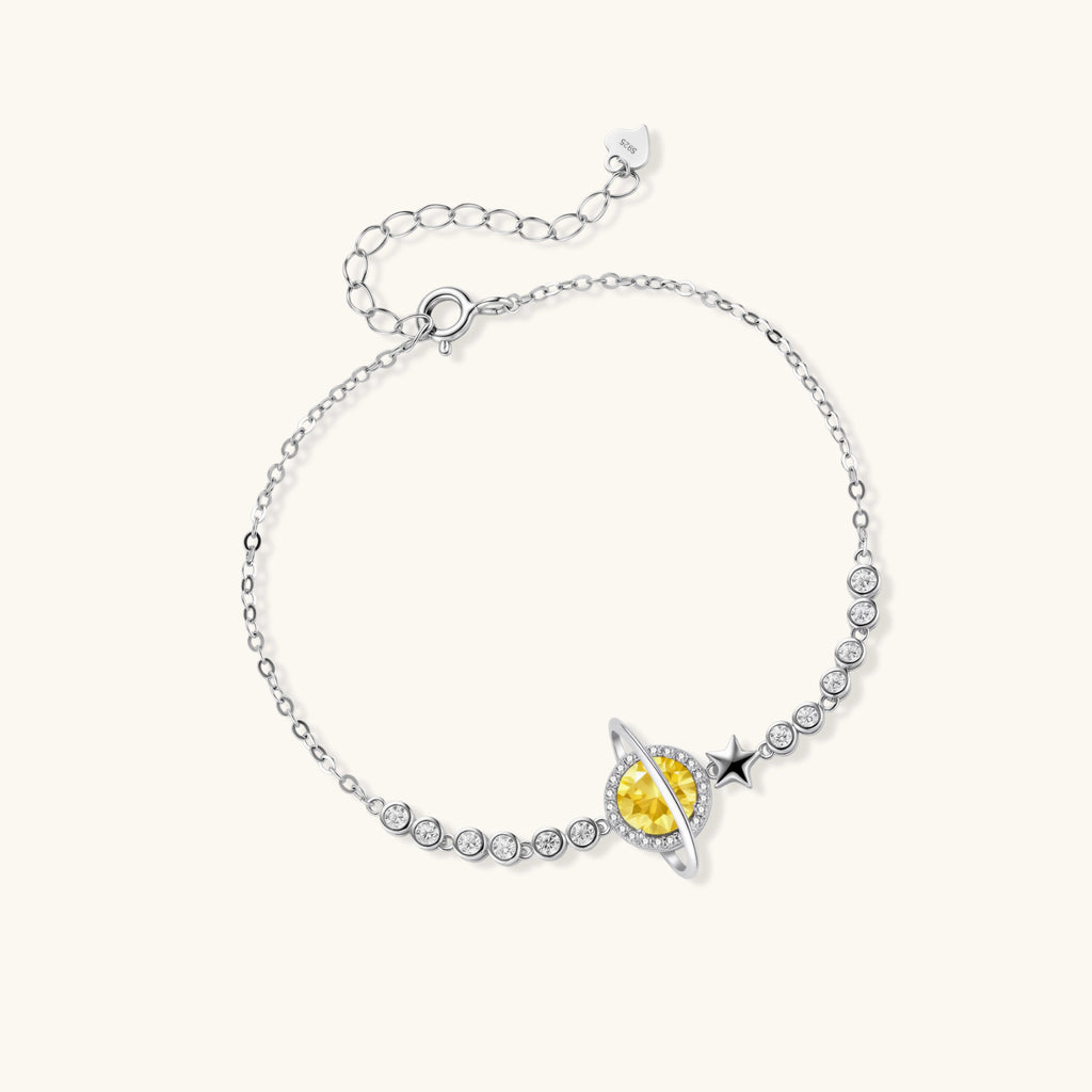 Silver bracelet with a yellow gemstone on a white background