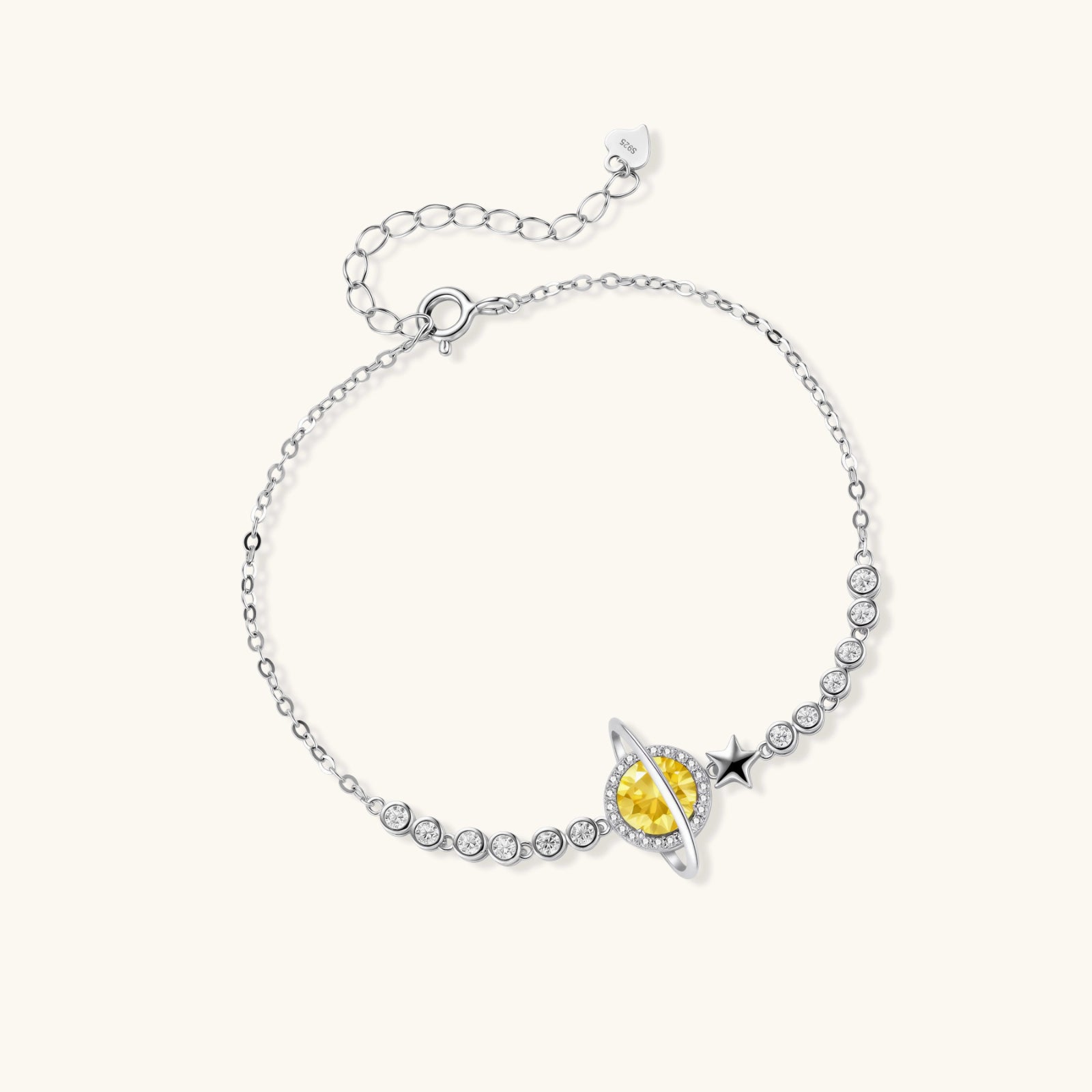 Silver bracelet with a yellow gemstone on a white background