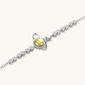 Silver bracelet with a yellow gemstone and star design on a white background