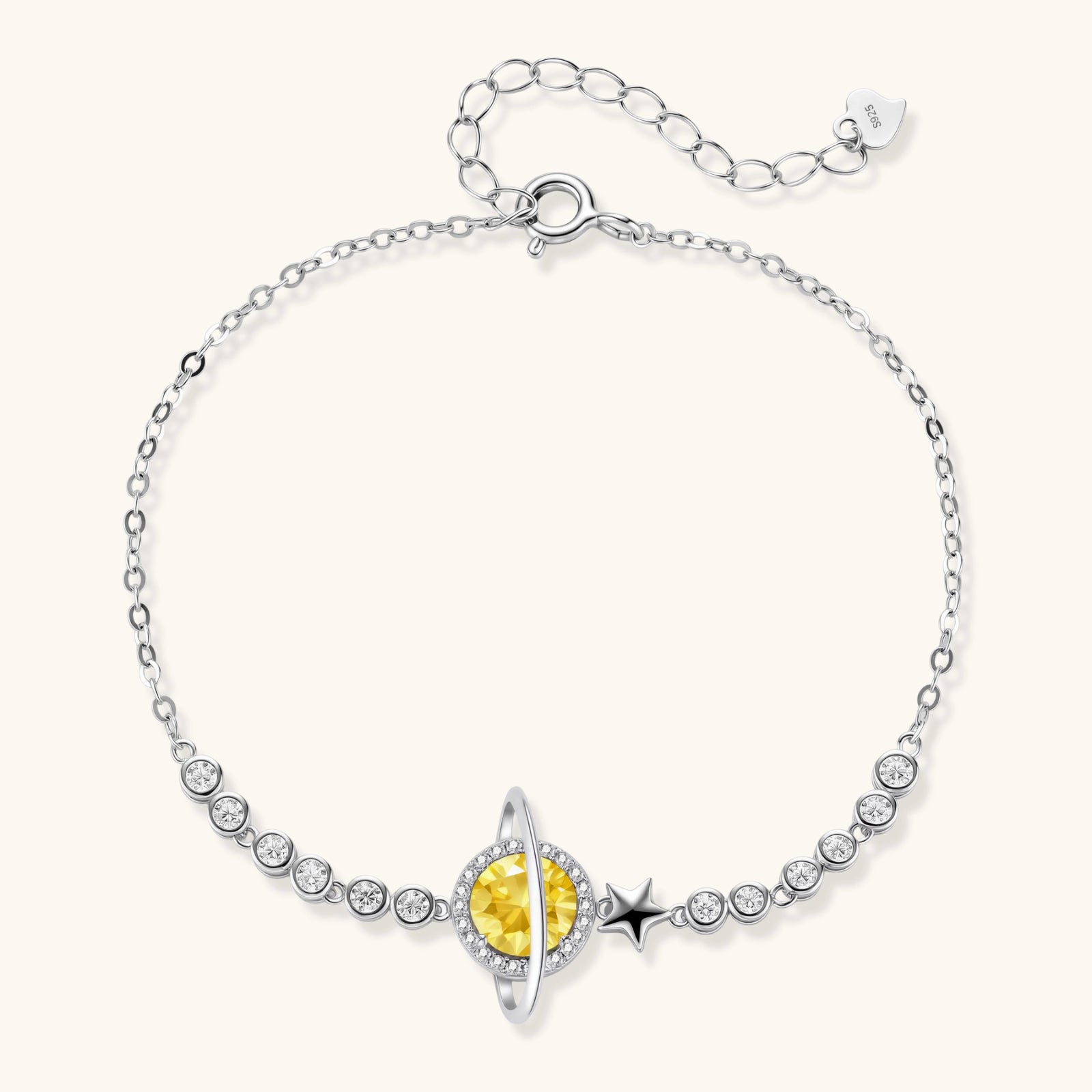 Silver bracelet with a yellow gemstone and star design on a white background