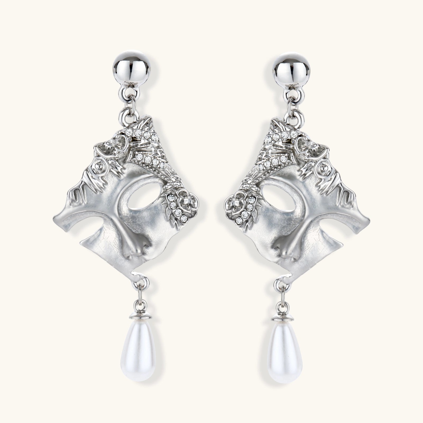Silver earrings with intricate designs and pearl-like droplets on a white background