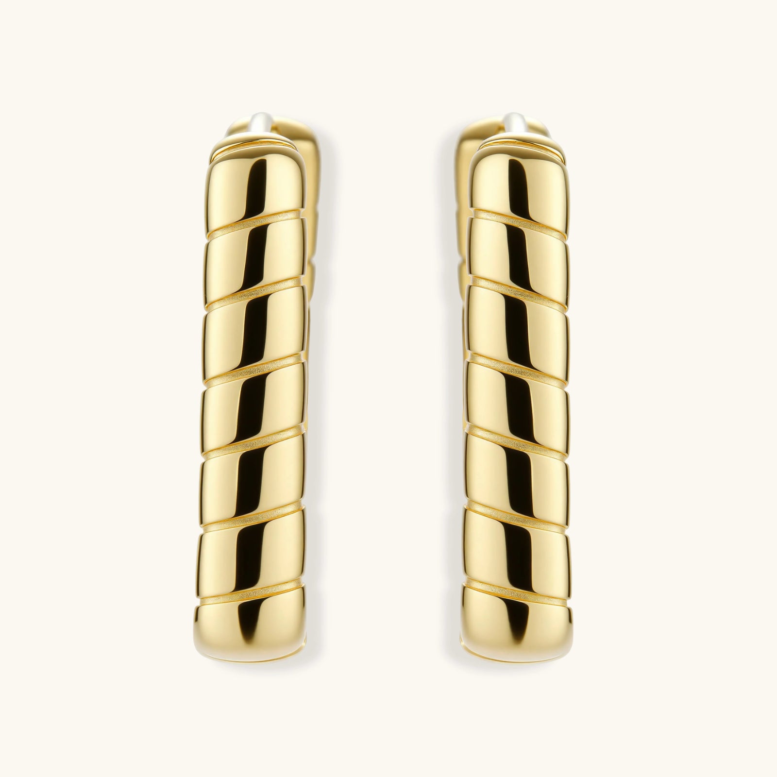 Pair of gold hoop earrings on a white background