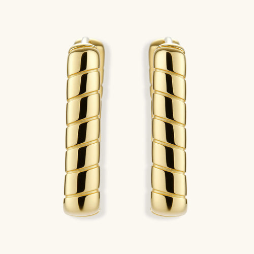 Pair of gold hoop earrings on a white background