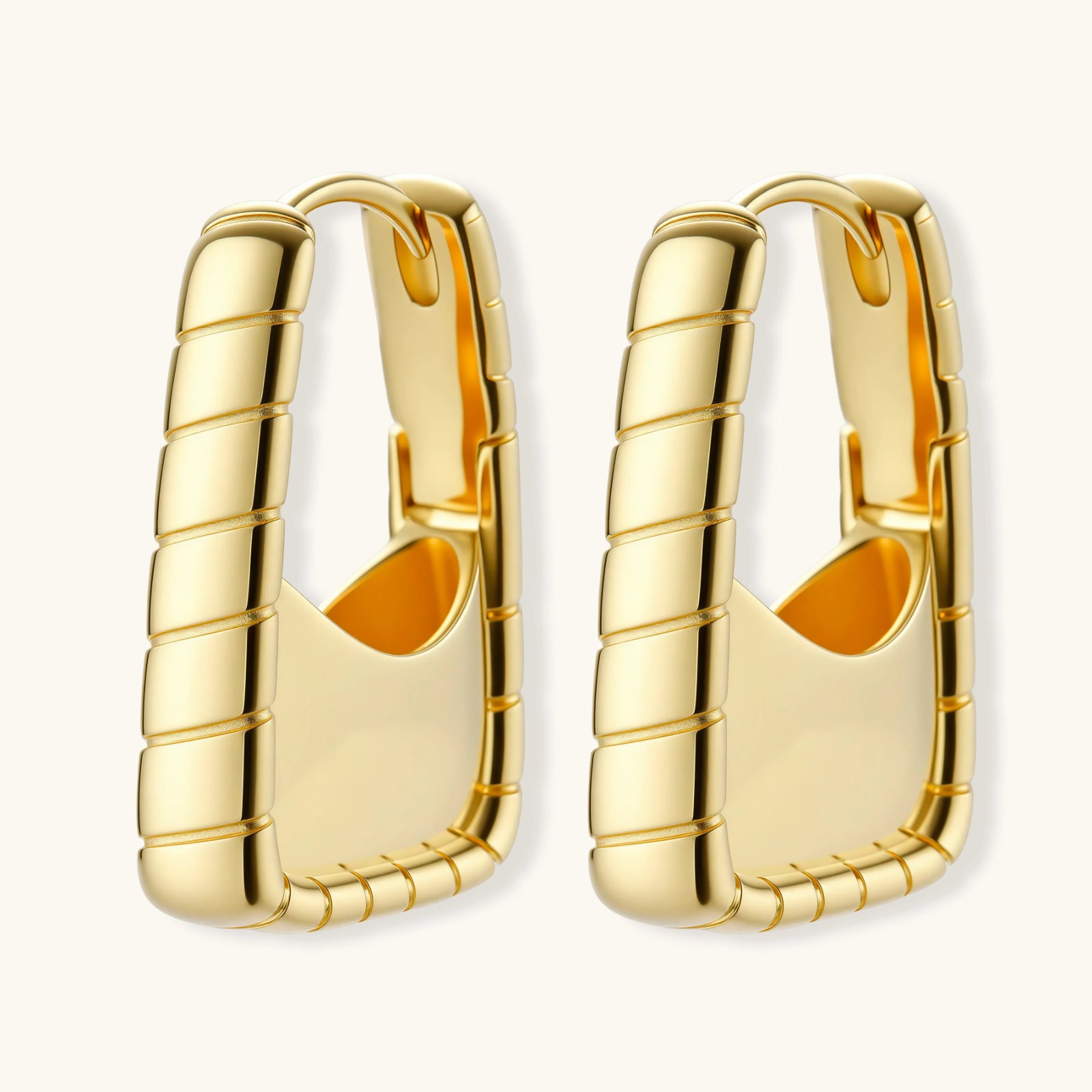 Pair of gold hoop earrings on a white background