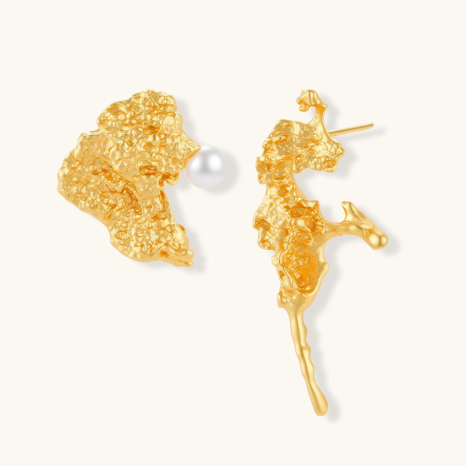 Gold coral reef style earrings with a pearl on a white background