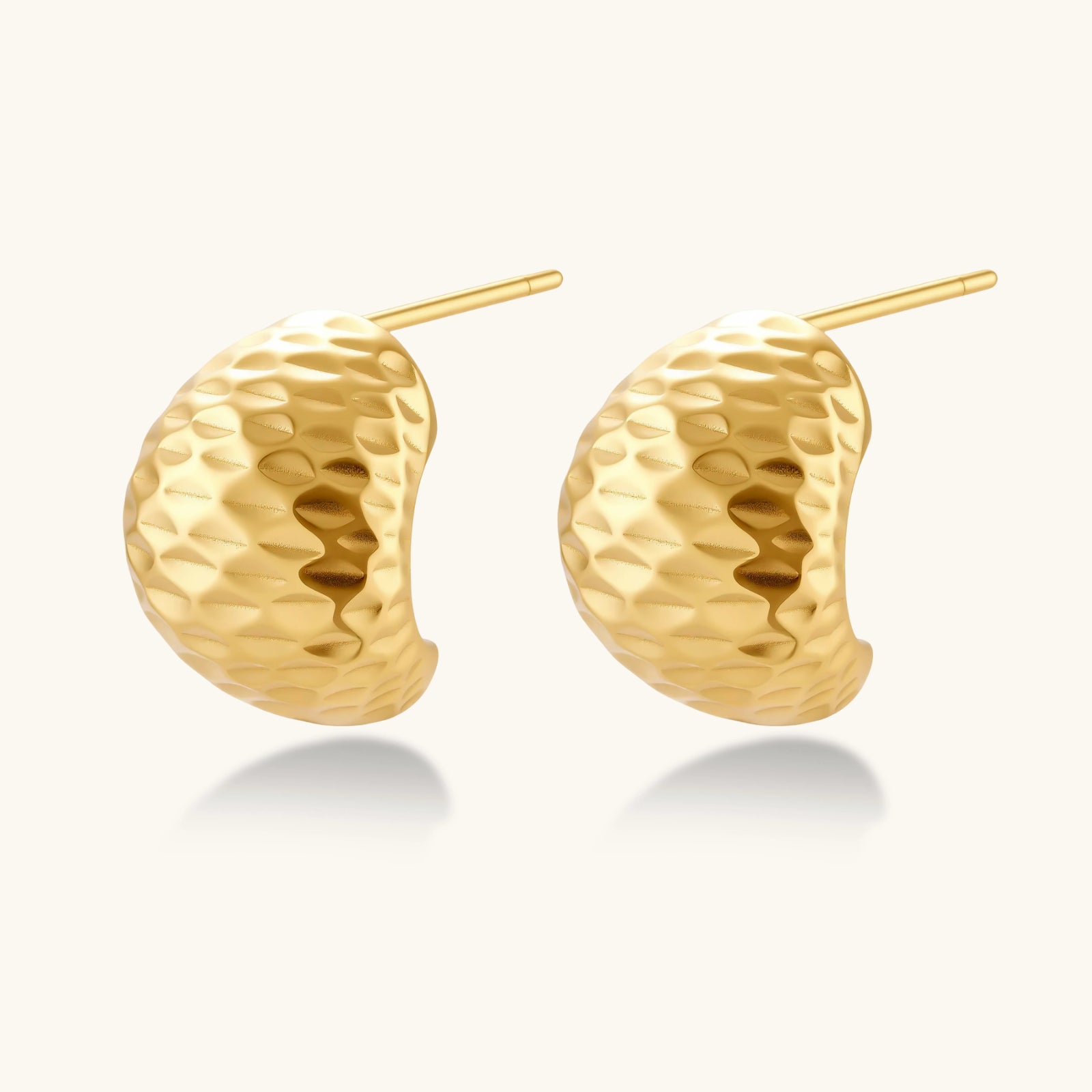 Pair of gold earrings on a white background