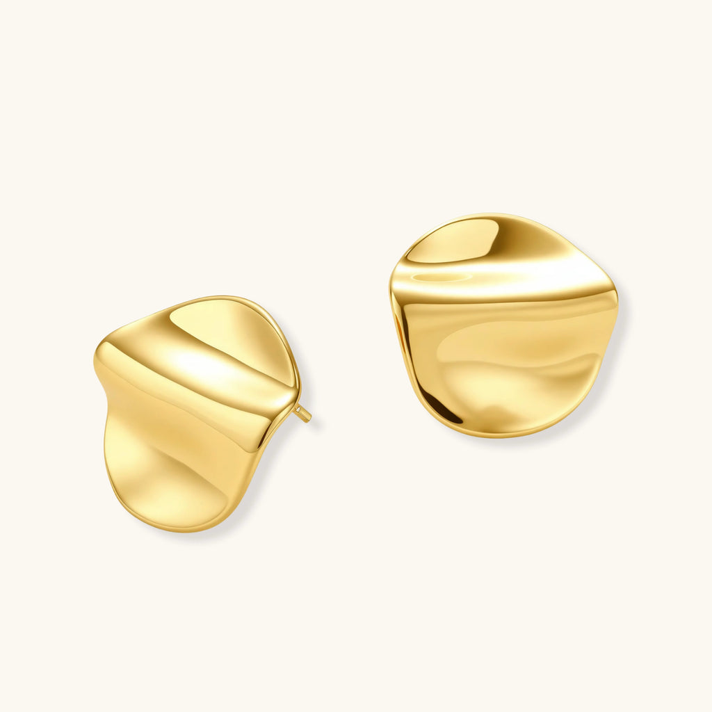 Pair of gold vermeil earrings with wavy design on a white background