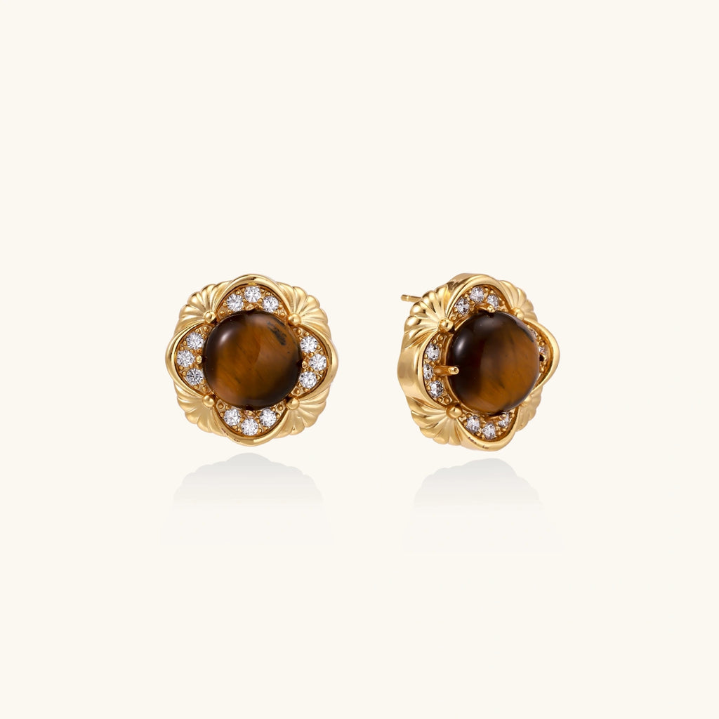 Gold earrings with brown gemstones and diamond accents on a white background