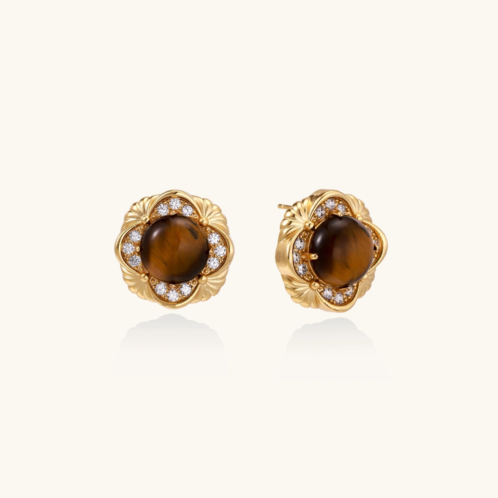 Gold earrings with brown gemstones and diamond accents on a white background