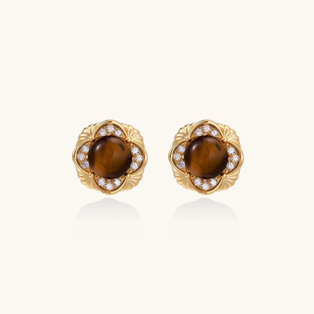 Gold earrings with brown gemstones and diamond accents on a white background