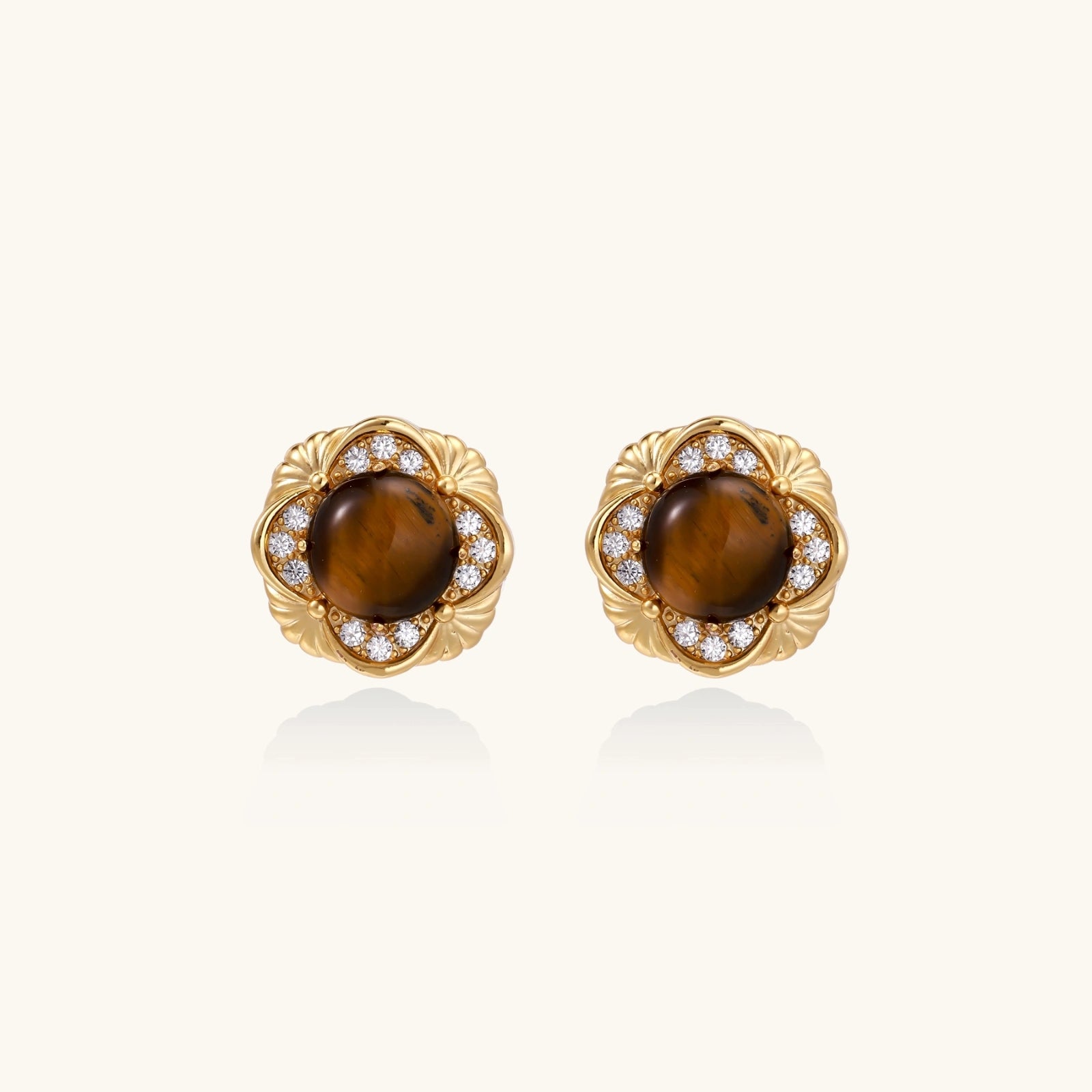 Gold earrings with brown gemstones and diamond accents on a white background