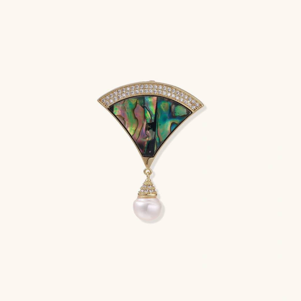 Jewelry broach piece with abalone shell and pearl on a white background