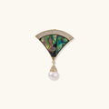 Jewelry broach piece with abalone shell and pearl on a white background