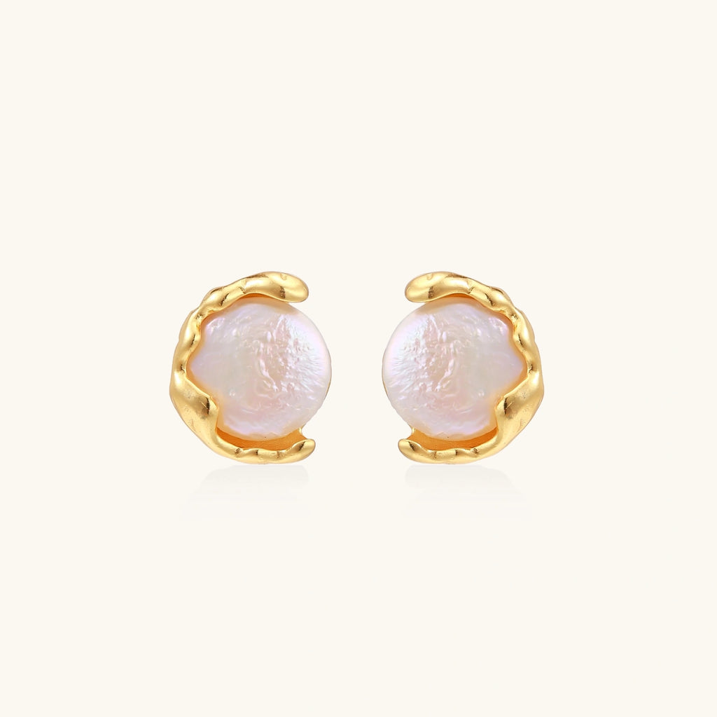 Pair of pearl earrings with gold settings on a white background