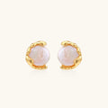Pair of pearl earrings with gold settings on a white background