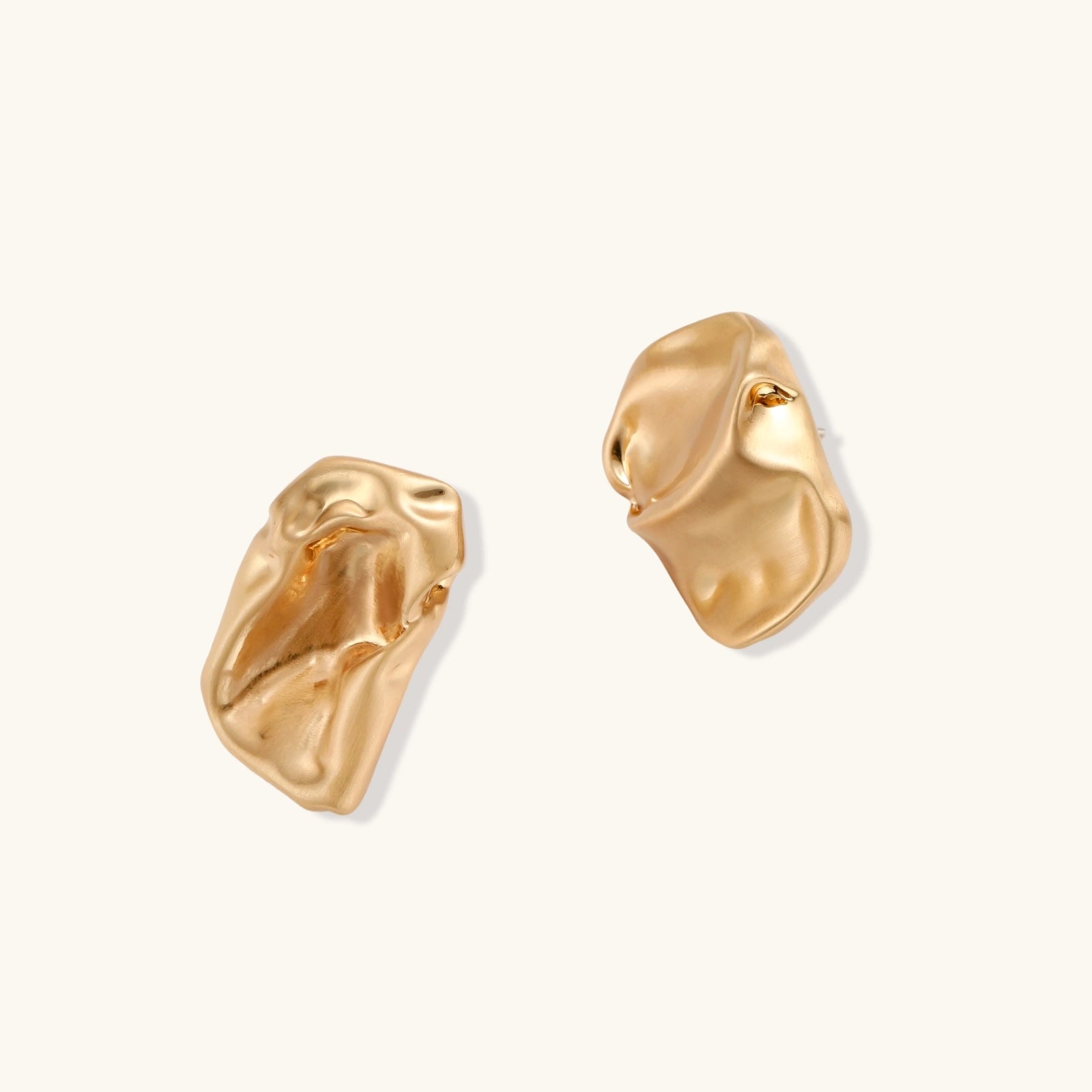 Pair of gold earrings on a white background