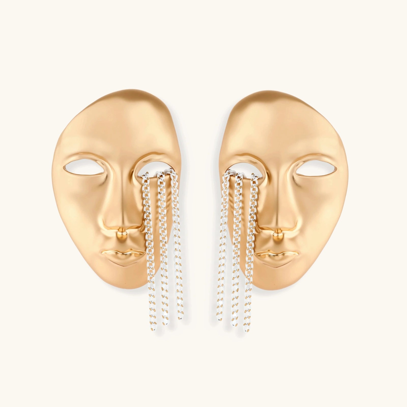 Gold face-shaped earrings with chain drops on a white background