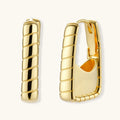 Gold hoop earrings on a white background