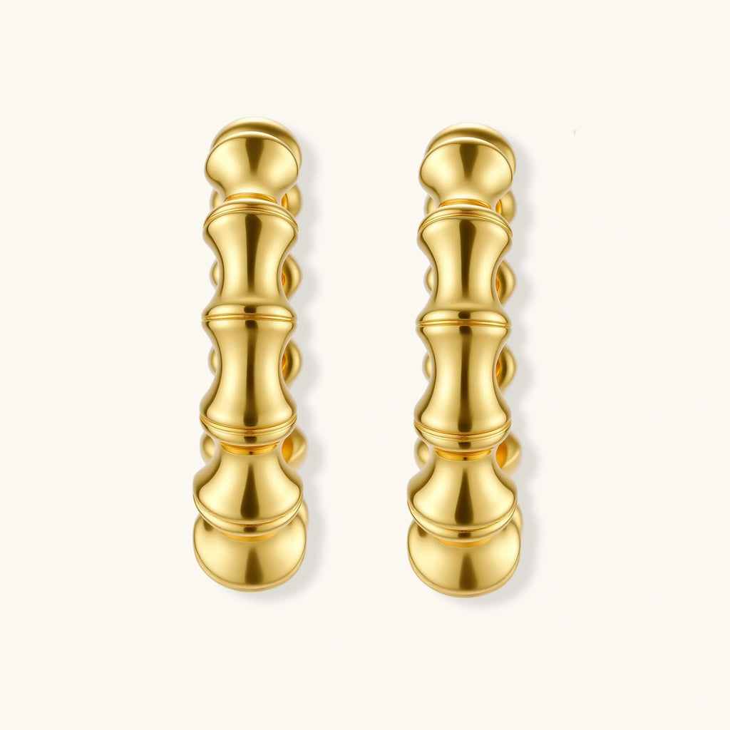 Pair of gold hoop earrings on a white background