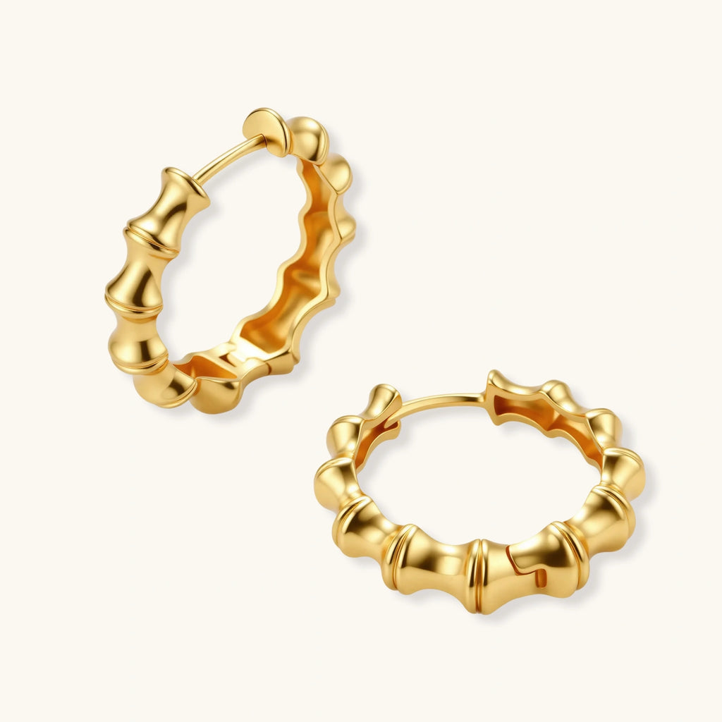 Gold hoop earrings on a white background