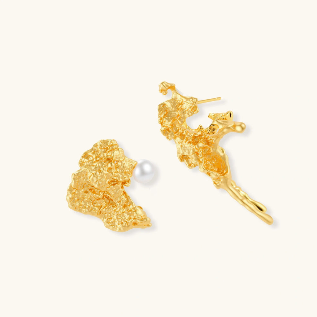 Gold coral reef with pearl earrings with a pearl on a white background