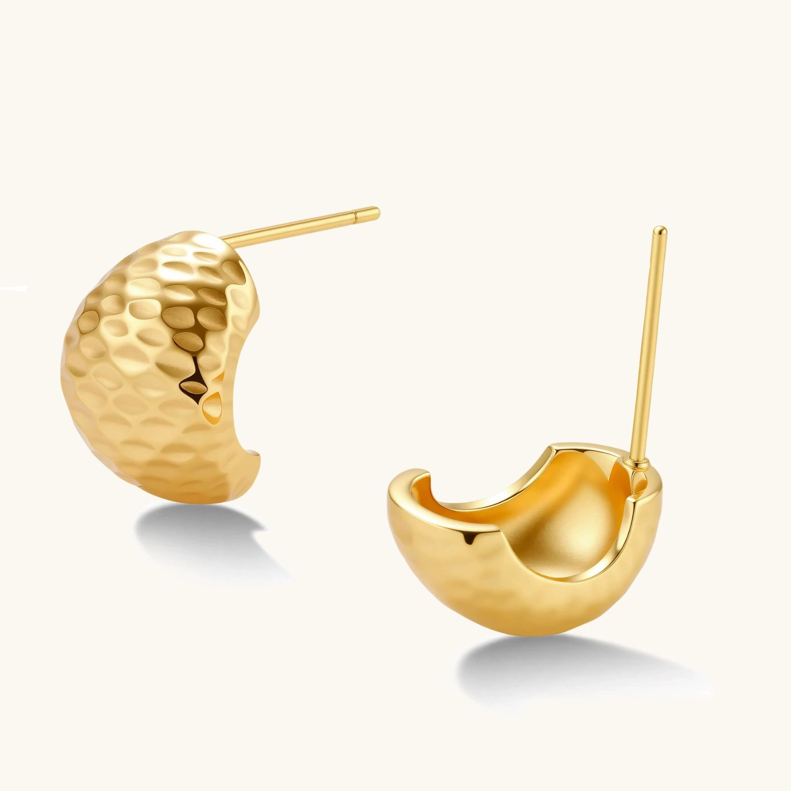 Gold earrings on a white background