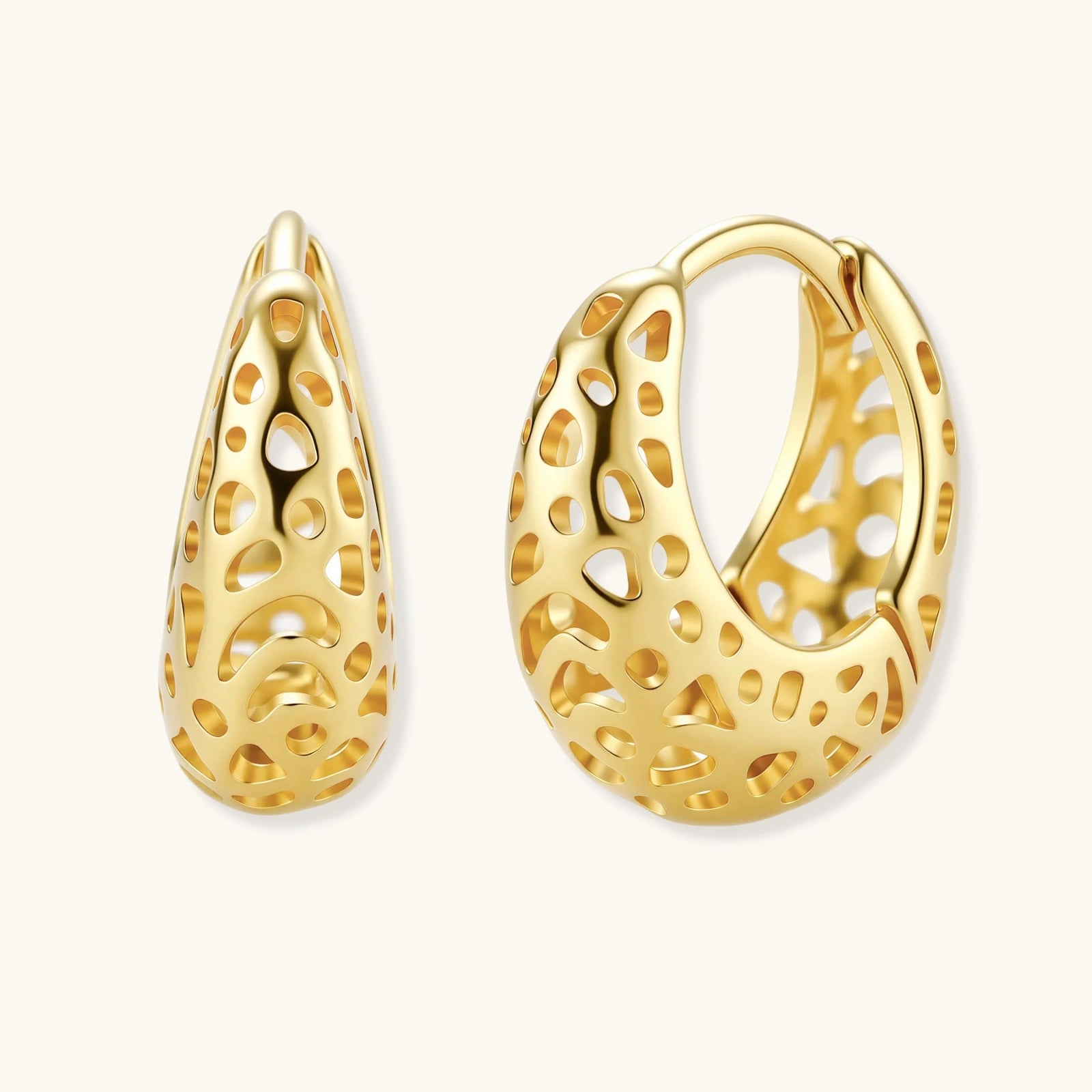 Gold hoop earrings with intricate designs on a white background