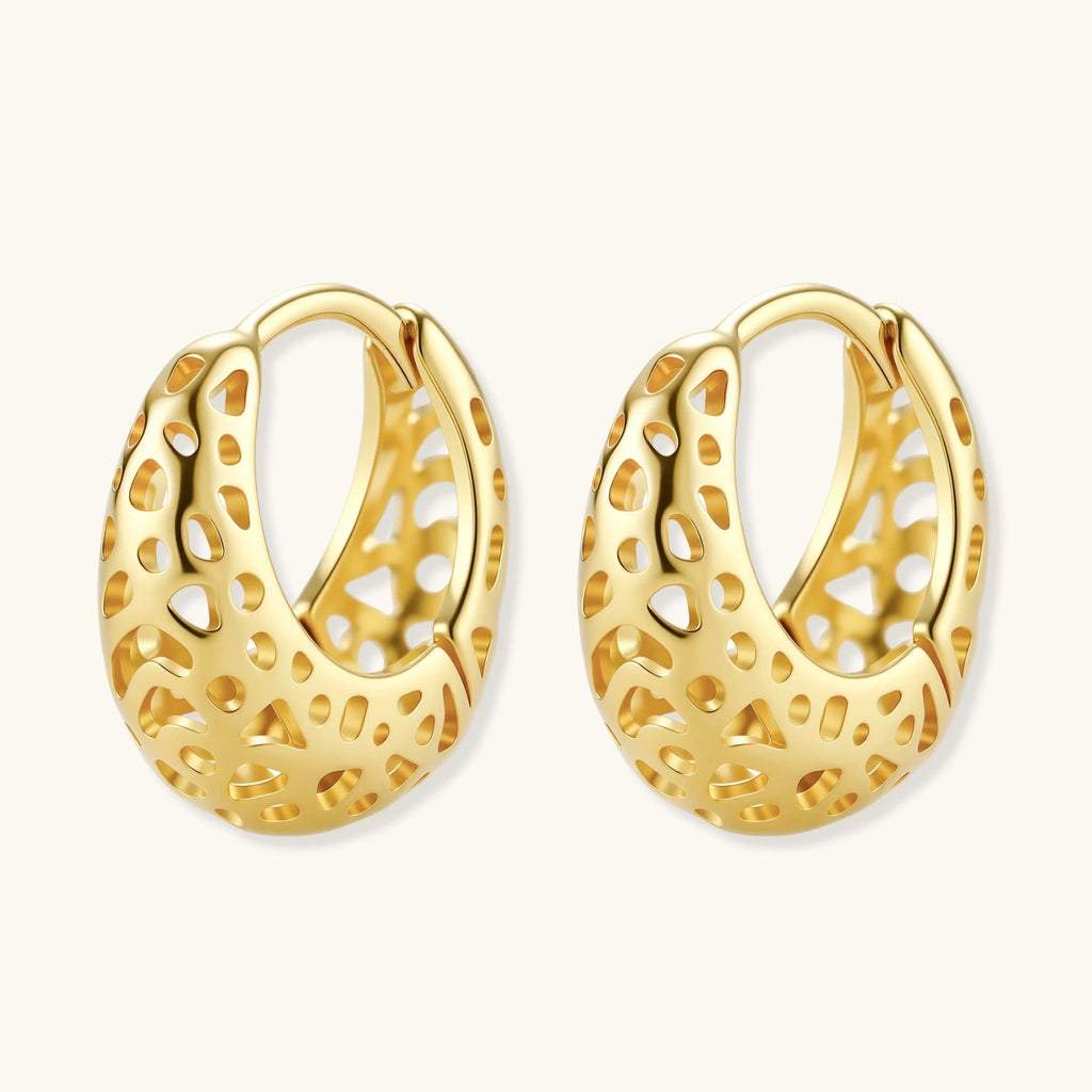 Gold hoop earrings with intricate designs on a white background