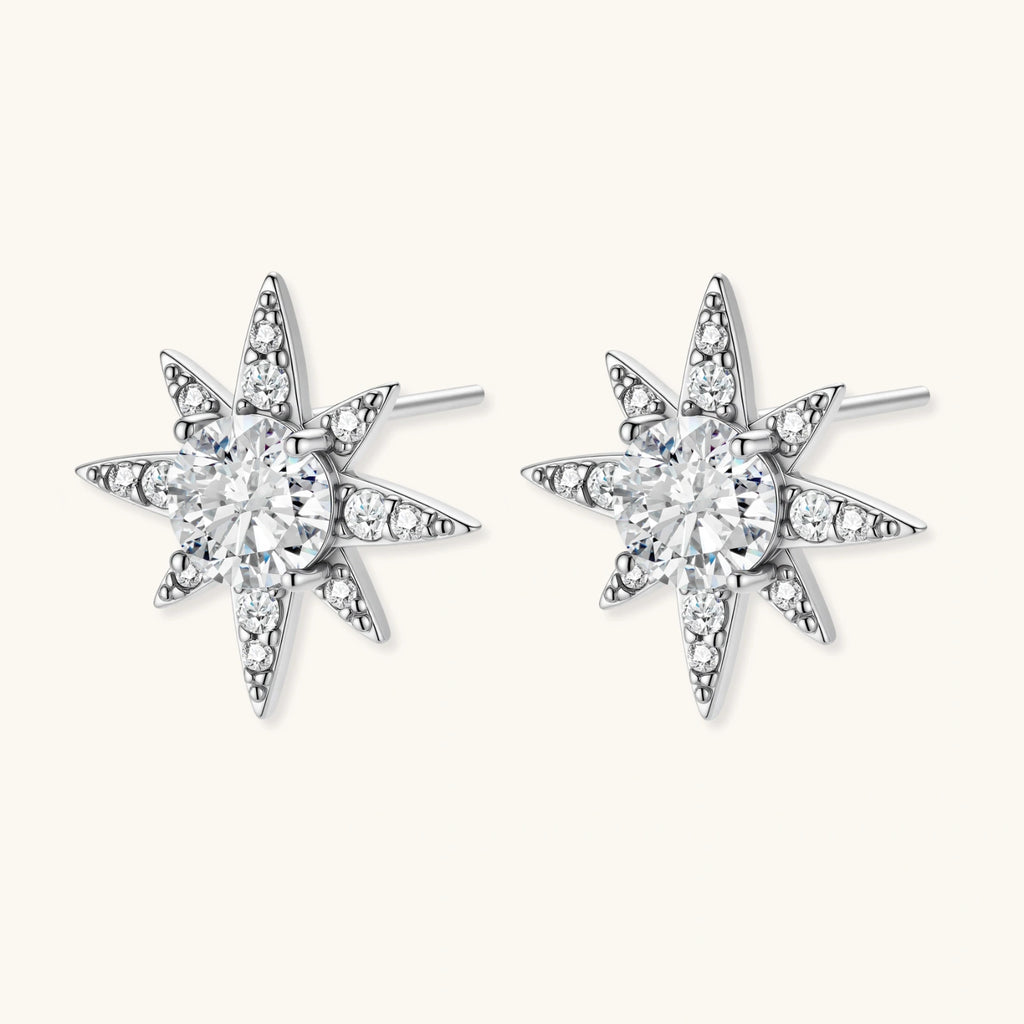 Star-shaped earrings with clear gemstones on a white background