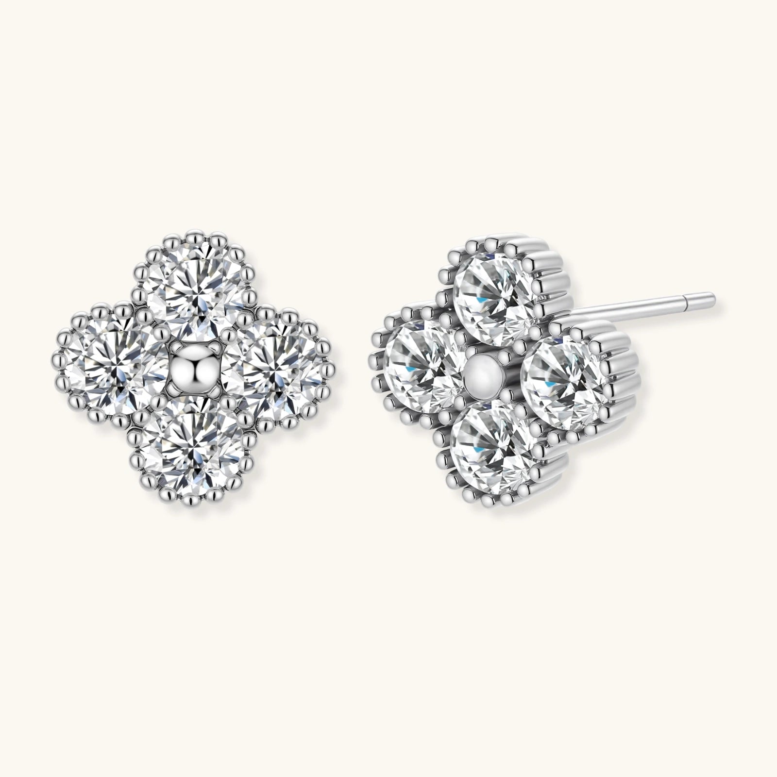 Pair of clover-shaped diamond stud earrings on a white background