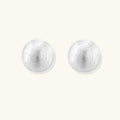 Pair of silver round earrings on a white background