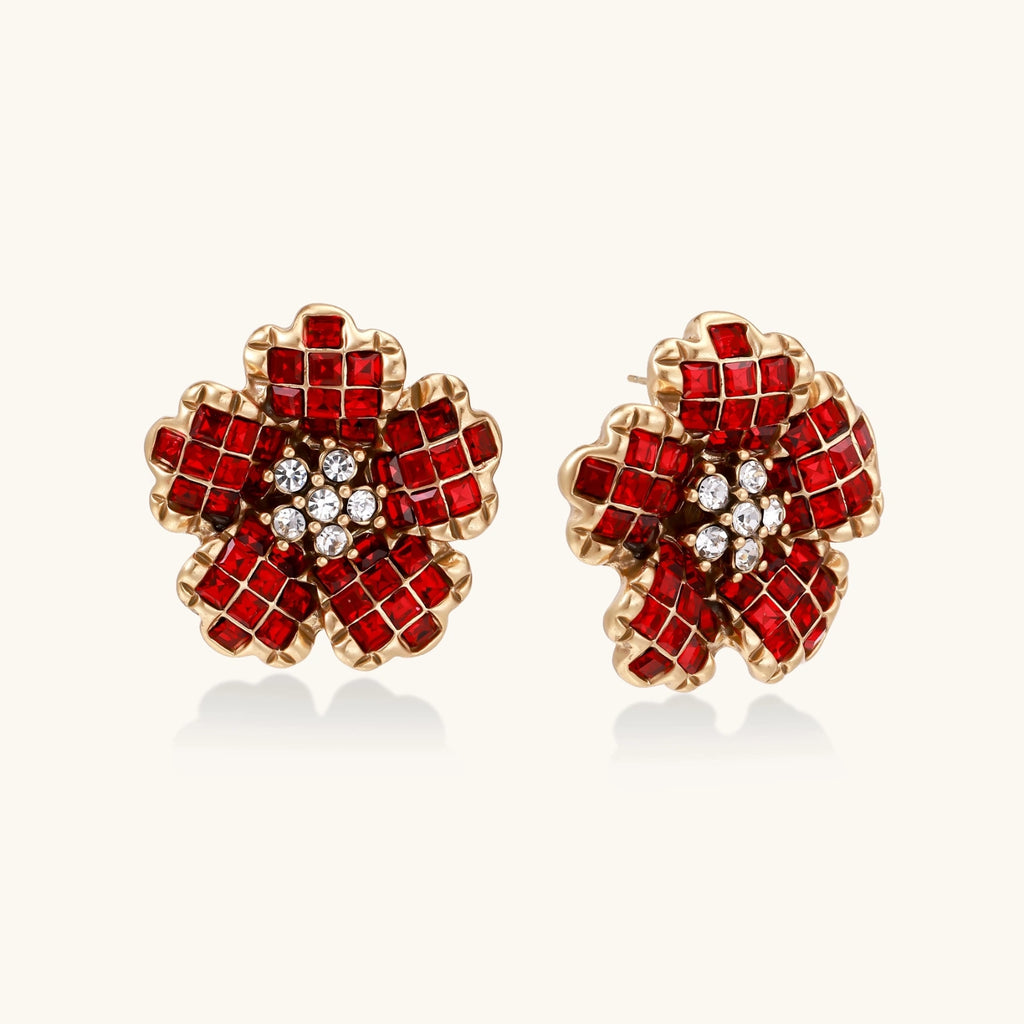 Pair of red floral crystal earrings with gold accents on a white background