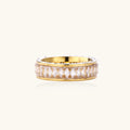 Gold ring with clear gemstones on a white background